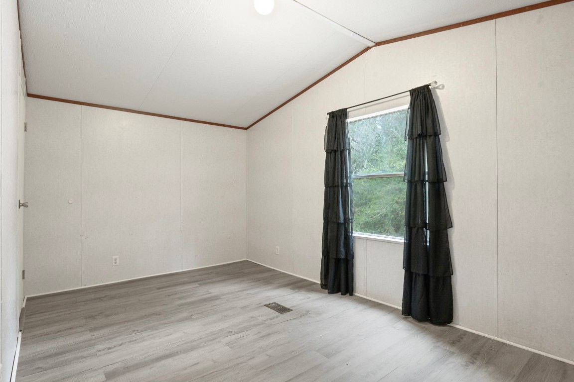 6493 Pappas Road Waller, TX 77484 - Photo 12 of 28 Secondary bedroom with natural light and flexible use options.
Ideal as a guest room, home office, or additional sleeping space, with a peaceful view of the surrounding property.