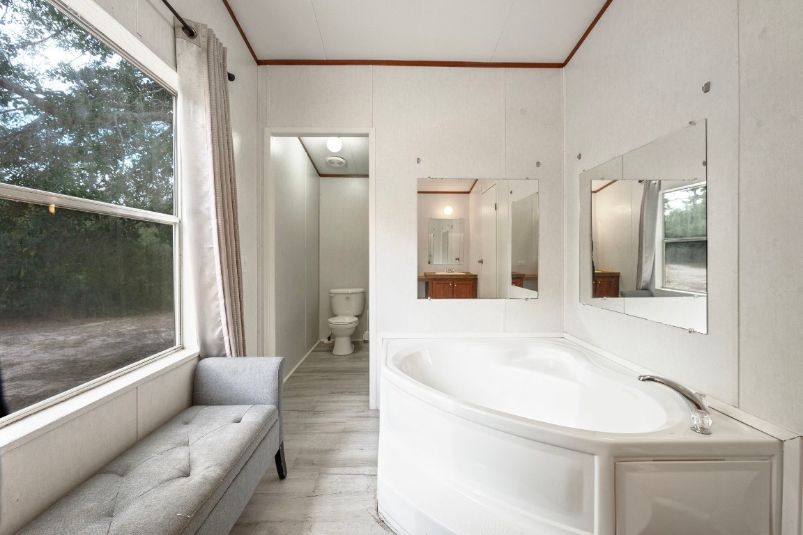 6493 Pappas Road Waller, TX 77484 - Photo 17 of 28 Deep soaking tub in primary bath, the perfect retreat for relaxation after a day at the nearby industrial hubs.