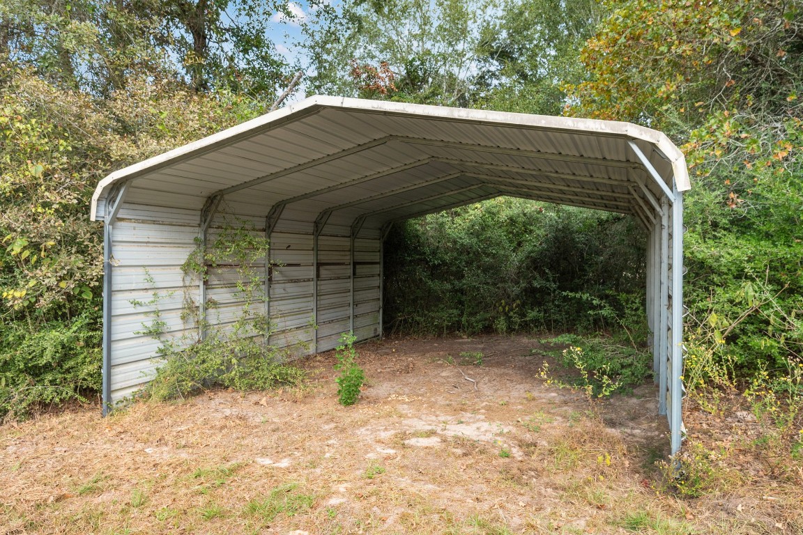 6493 Pappas Road Waller, TX 77484 - Photo 23 of 28 Interior view of RV cover showing generous height clearance for trailers and recreational vehicles.