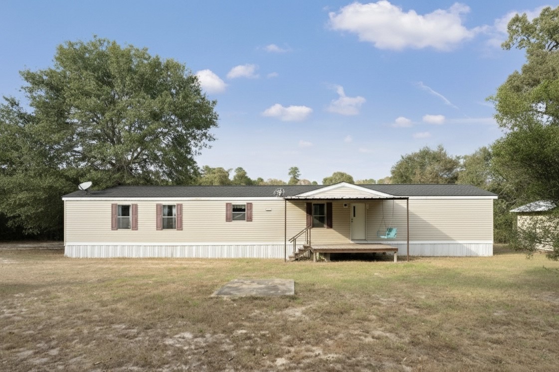 6493 Pappas Road Waller, TX 77484 - Photo 6 of 28 Wide front elevation highlighting the home’s placement within the property.
Surrounded by mature trees and open space, emphasizing privacy and room to expand.