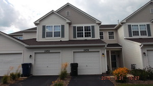 2474 Golf Ridge Circle, Unit 2474 Naperville, IL 60563 - Photo 1 of 16 a front view of a house with a yard