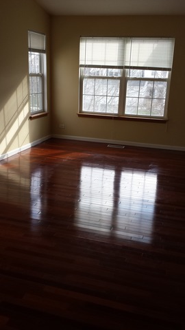2474 Golf Ridge Circle, Unit 2474 Naperville, IL 60563 - Photo 3 of 16 a view of empty room with wooden floor and fan