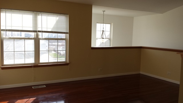 2474 Golf Ridge Circle, Unit 2474 Naperville, IL 60563 - Photo 4 of 16 an empty room with wooden floor and windows