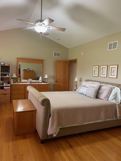 1976 East 24th Road Ransom, IL 60470 - Photo 17 of 32 a bedroom with a large bed and a chandelier
