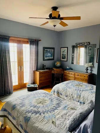 a bedroom with a large bed and a chandelier