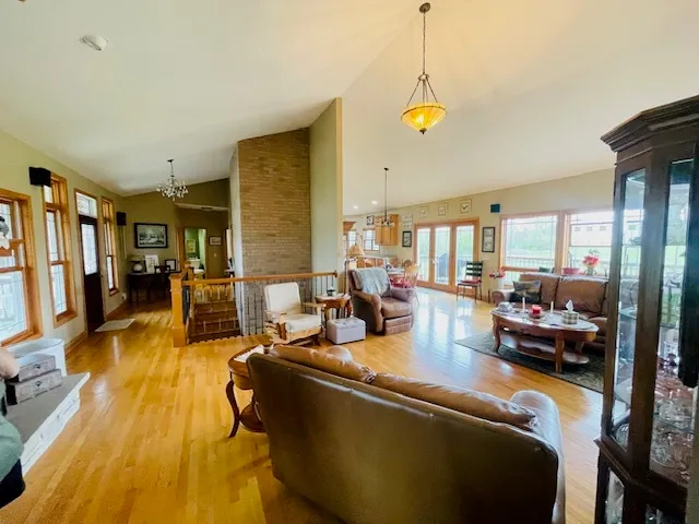 a living room with fireplace furniture and a chandelier