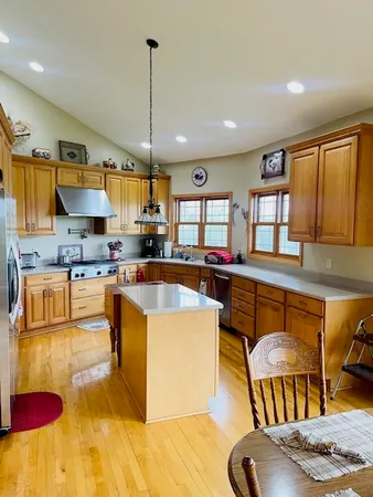 a large kitchen with stainless steel appliances lots of counter space and breakfast area