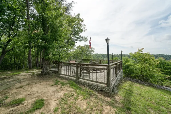 a view of backyard of house with wooden fence