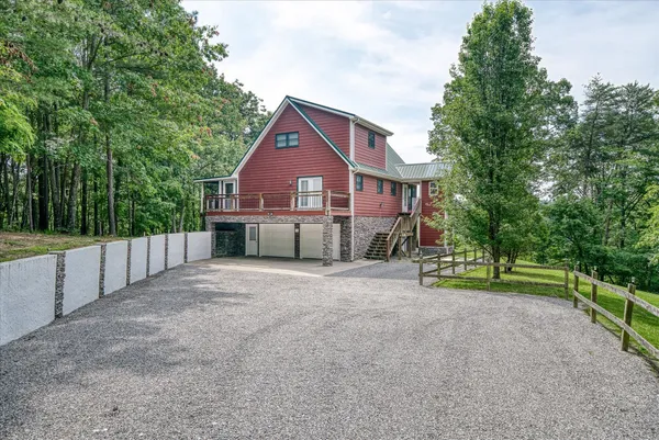 a view of a house with large trees