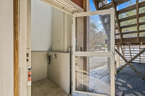 a dining room with furniture large windows and wooden floor