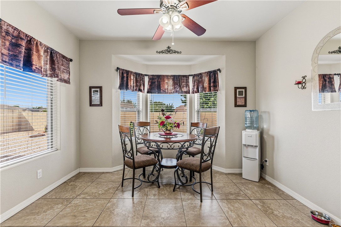 4143 North Stampede Road Kingman, AZ 86401 - Photo 15 of 42 Dining area featuring large-format tile flooring and a multi-pane bay window