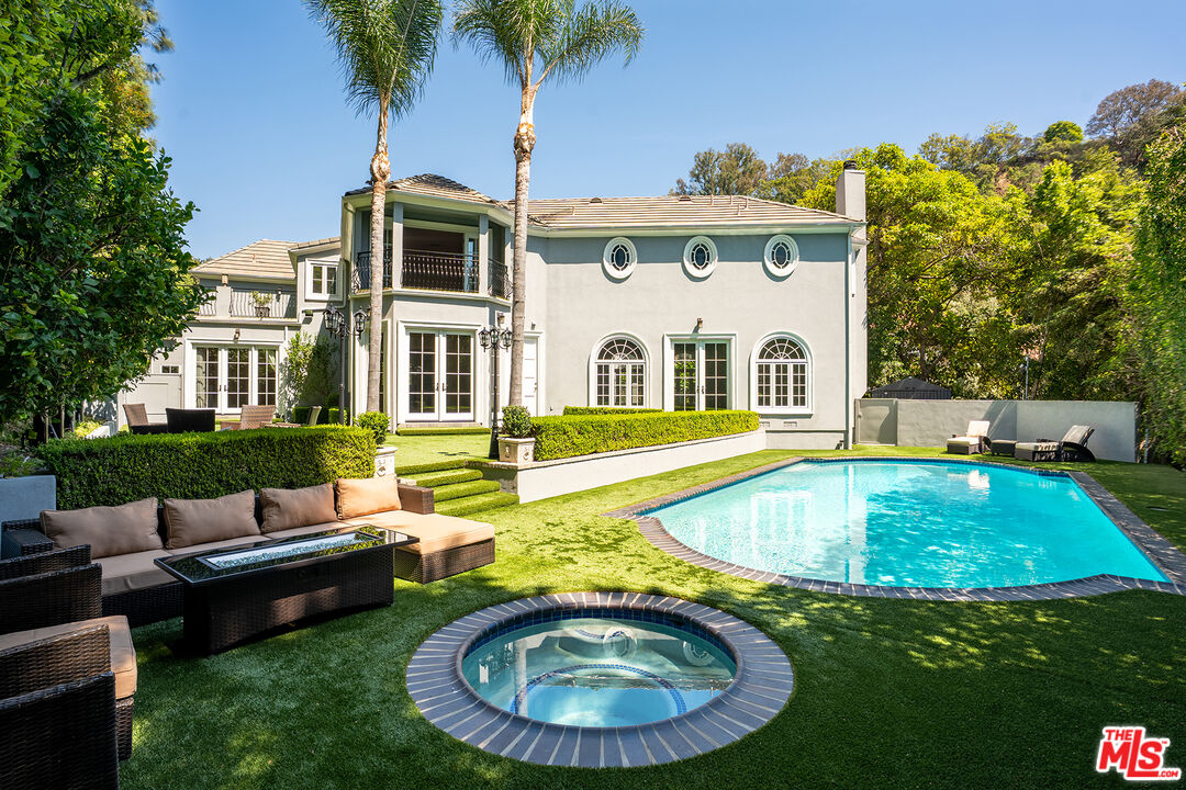 1357 Schuyler Road Beverly Hills, CA 90210 - Photo 1 of 9 a view of a house with swimming pool and porch