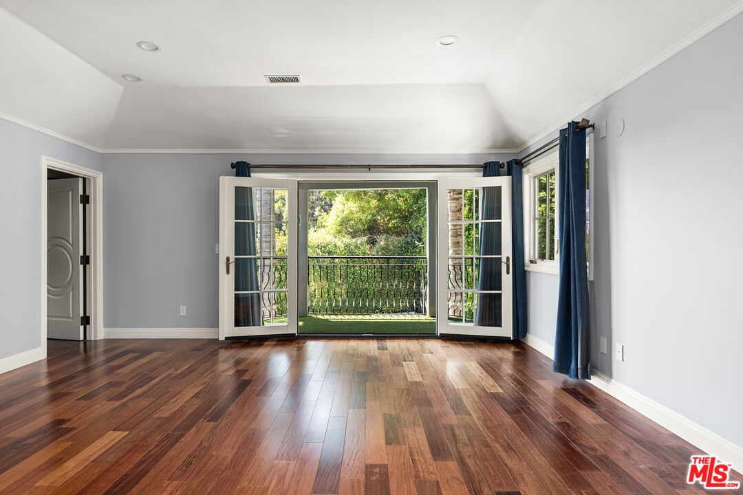 1357 Schuyler Road Beverly Hills, CA 90210 - Photo 6 of 9 a view of a room with wooden floor