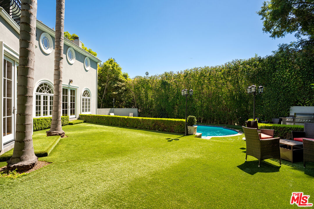 1357 Schuyler Road Beverly Hills, CA 90210 - Photo 9 of 9 a view of a house with swimming pool and sitting area