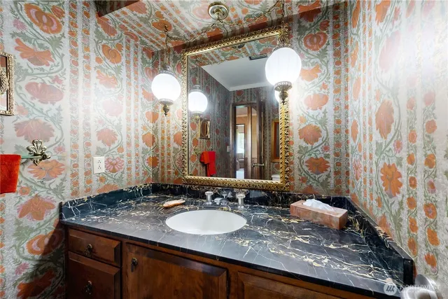 a kitchen that has a lot of cabinets a sink and a dishwasher in it