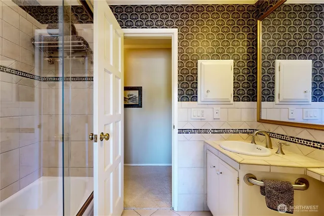 a bathroom with double vanity sink and a mirror