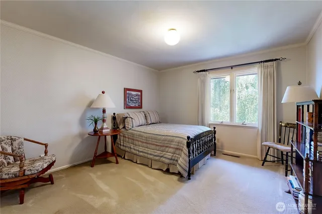 a bedroom with furniture and a window