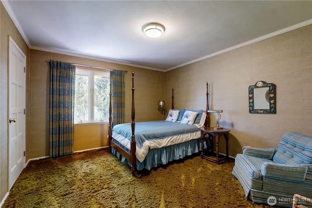 a view of a hallway with bathroom and glass door