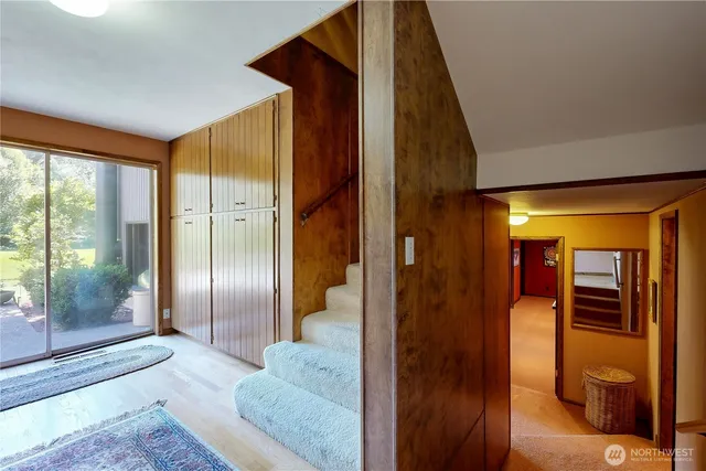 a view of a livingroom with furniture and a floor to ceiling window