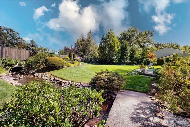 a view of a garden with lawn chairs