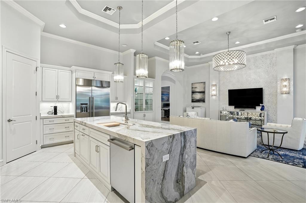 17483 Via Navona Way Miromar Lakes, FL 33913 - Photo 11 of 50 a large white kitchen with a large island in the center