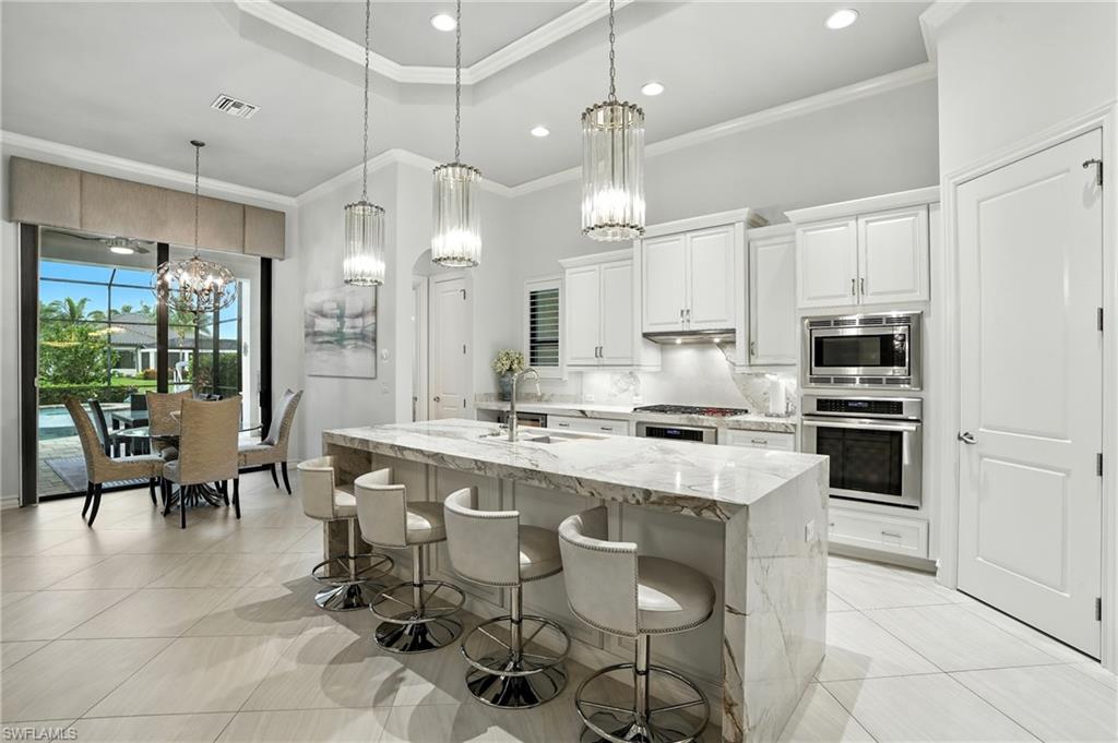 17483 Via Navona Way Miromar Lakes, FL 33913 - Photo 12 of 50 a large kitchen with cabinets