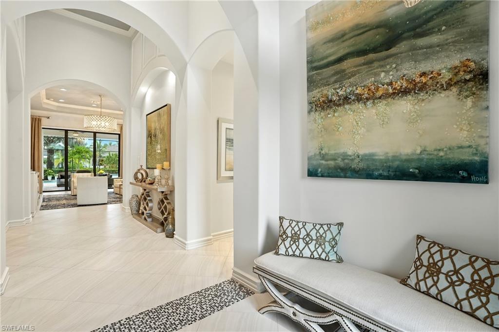 17483 Via Navona Way Miromar Lakes, FL 33913 - Photo 13 of 50 a living room with furniture and a floor to ceiling window