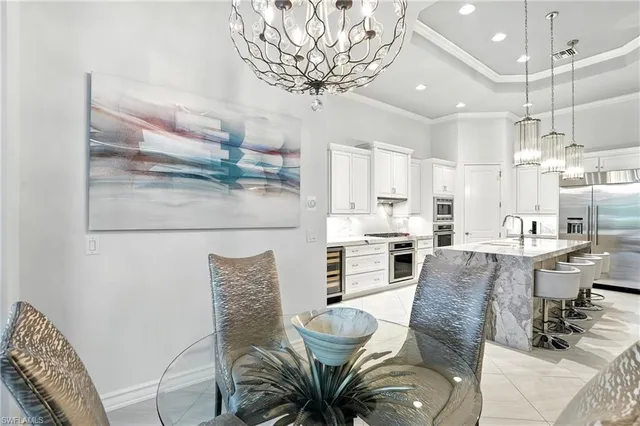 a view of a dining room with furniture a chandelier and wooden floor