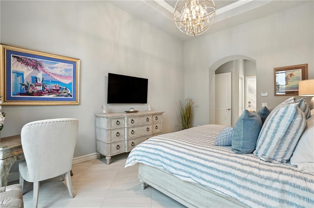 17483 Via Navona Way Miromar Lakes, FL 33913 - Photo 23 of 50 a bedroom with furniture and a flat screen tv