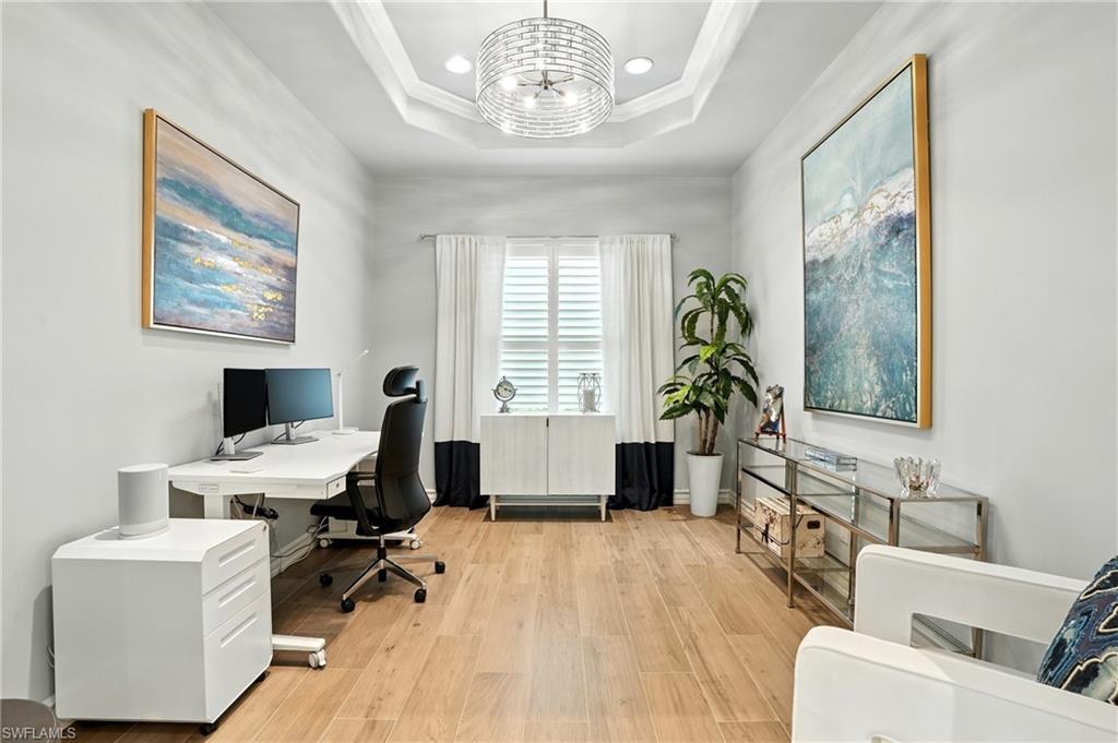 17483 Via Navona Way Miromar Lakes, FL 33913 - Photo 24 of 50 a living room with furniture a chandelier and a window