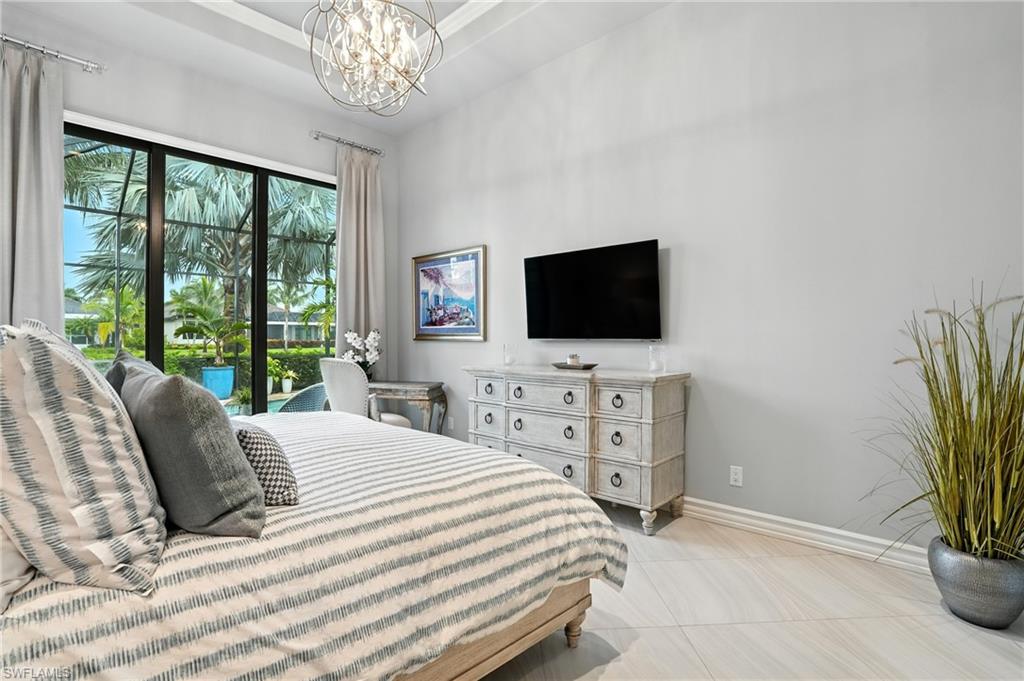 17483 Via Navona Way Miromar Lakes, FL 33913 - Photo 25 of 50 a bedroom with a bed and a flat screen tv