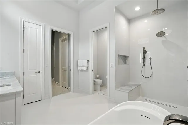 a bathroom with a white bath tub and shower