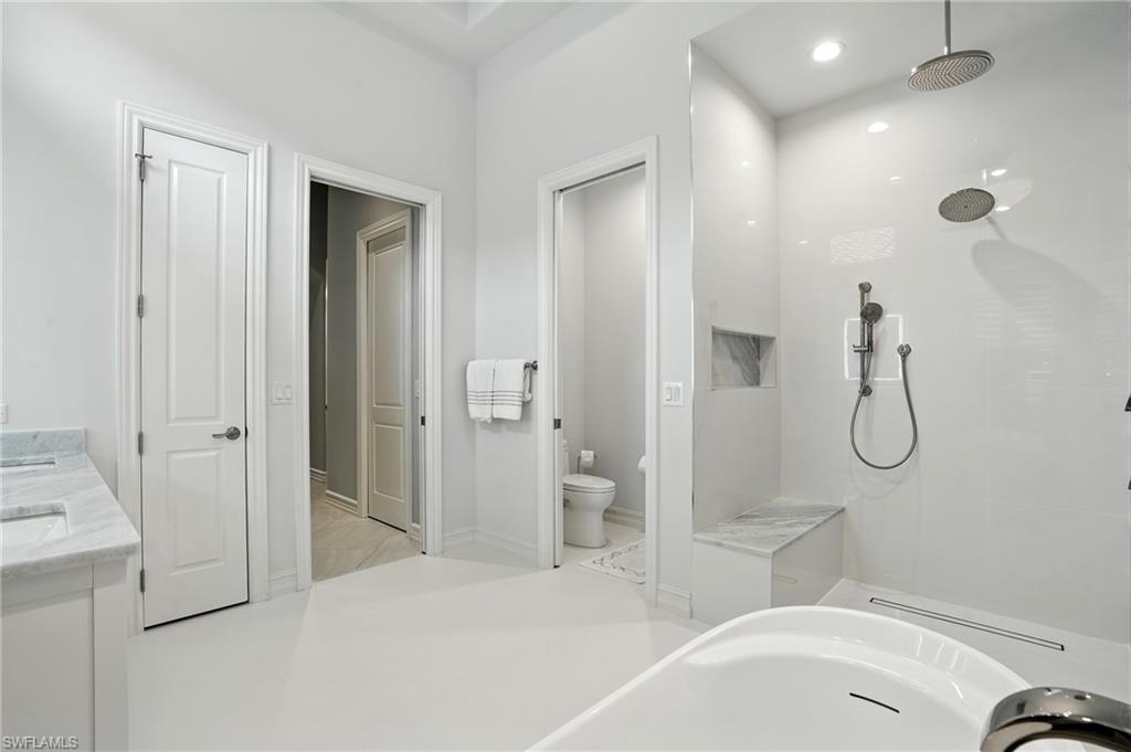 17483 Via Navona Way Miromar Lakes, FL 33913 - Photo 26 of 50 a bathroom with a bathtub and a shower