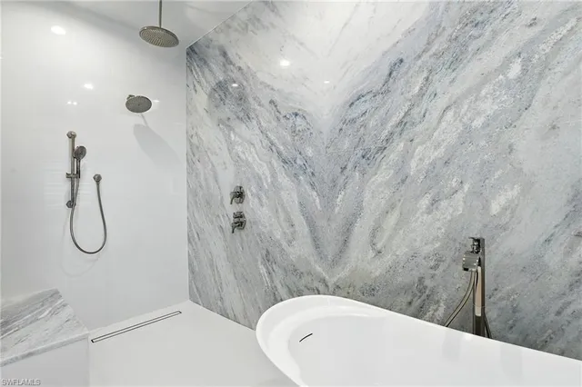 a bathroom with a double vanity sink a mirror and a bathtub