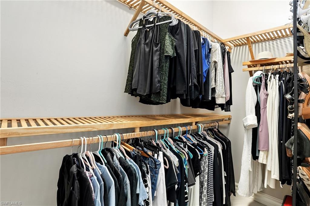 17483 Via Navona Way Miromar Lakes, FL 33913 - Photo 29 of 50 a view of walk in closet with clothes and shoes