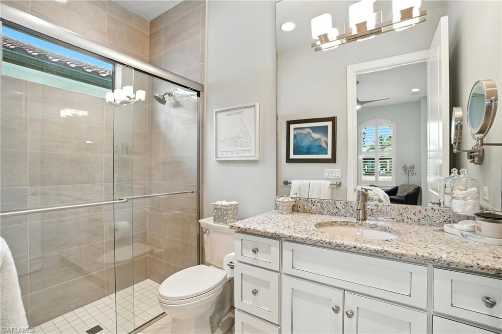 17483 Via Navona Way Miromar Lakes, FL 33913 - Photo 33 of 50 a bathroom with a granite countertop sink toilet and shower