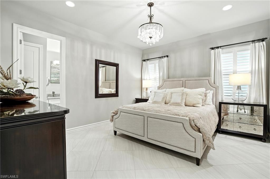 17483 Via Navona Way Miromar Lakes, FL 33913 - Photo 36 of 50 a bed room with a bed and a window