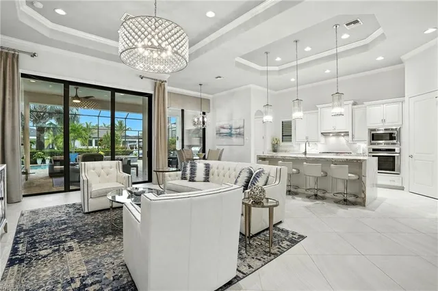 a room with stainless steel appliances kitchen island granite countertop a sink and cabinets