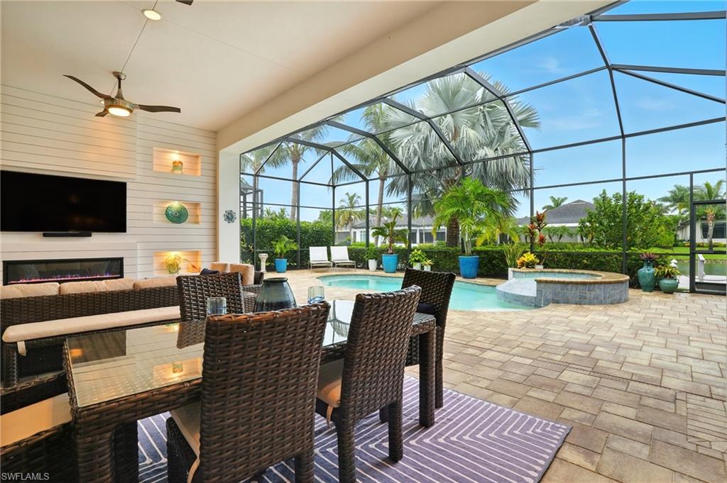 17483 Via Navona Way Miromar Lakes, FL 33913 - Photo 45 of 50 a view of a patio with dining table and chairs