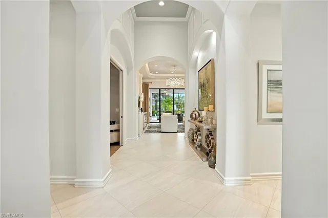 a view of a hallway with windows and a livingroom view