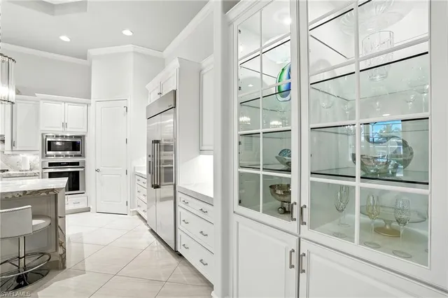 a kitchen with stainless steel appliances kitchen island granite countertop a refrigerator and cabinets