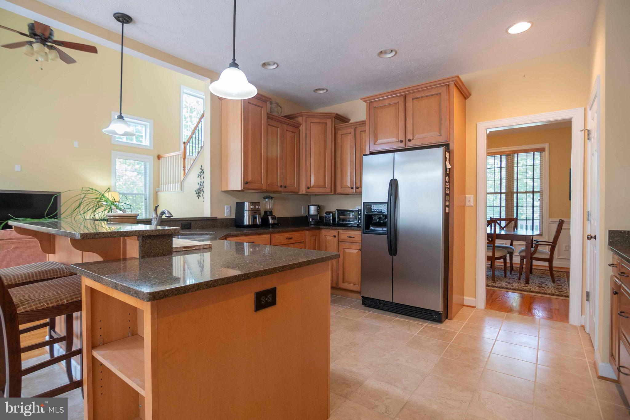 168 Thomas Drive Middletown, VA 22645 - Photo 41 of 66 a kitchen with stainless steel appliances granite countertop a refrigerator a sink a stove and a wooden floors