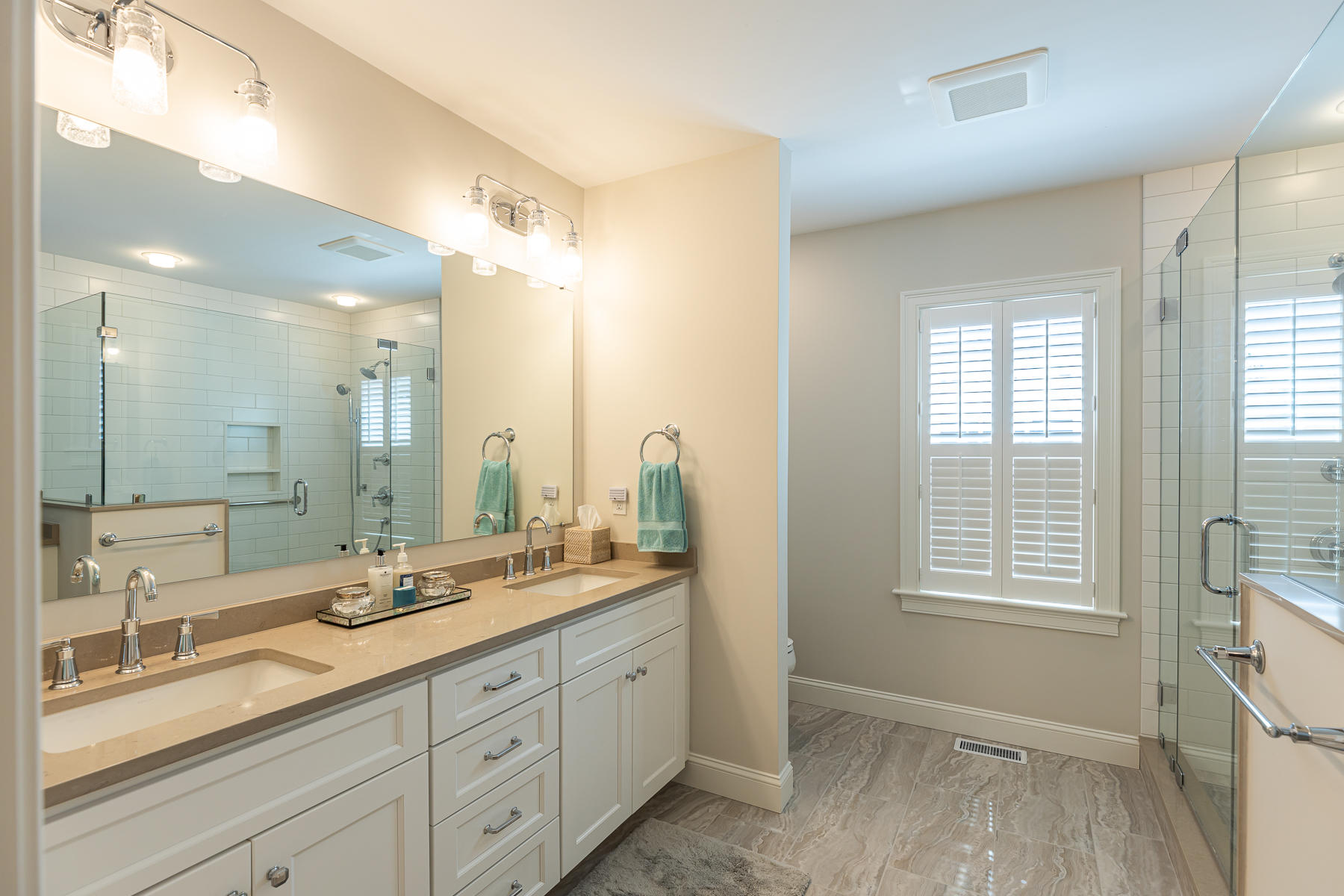 62 Cottage Lane Mashpee, MA 02649 - Photo 29 of 64 a spacious bathroom with double vanity a mirror a vanity and a shower