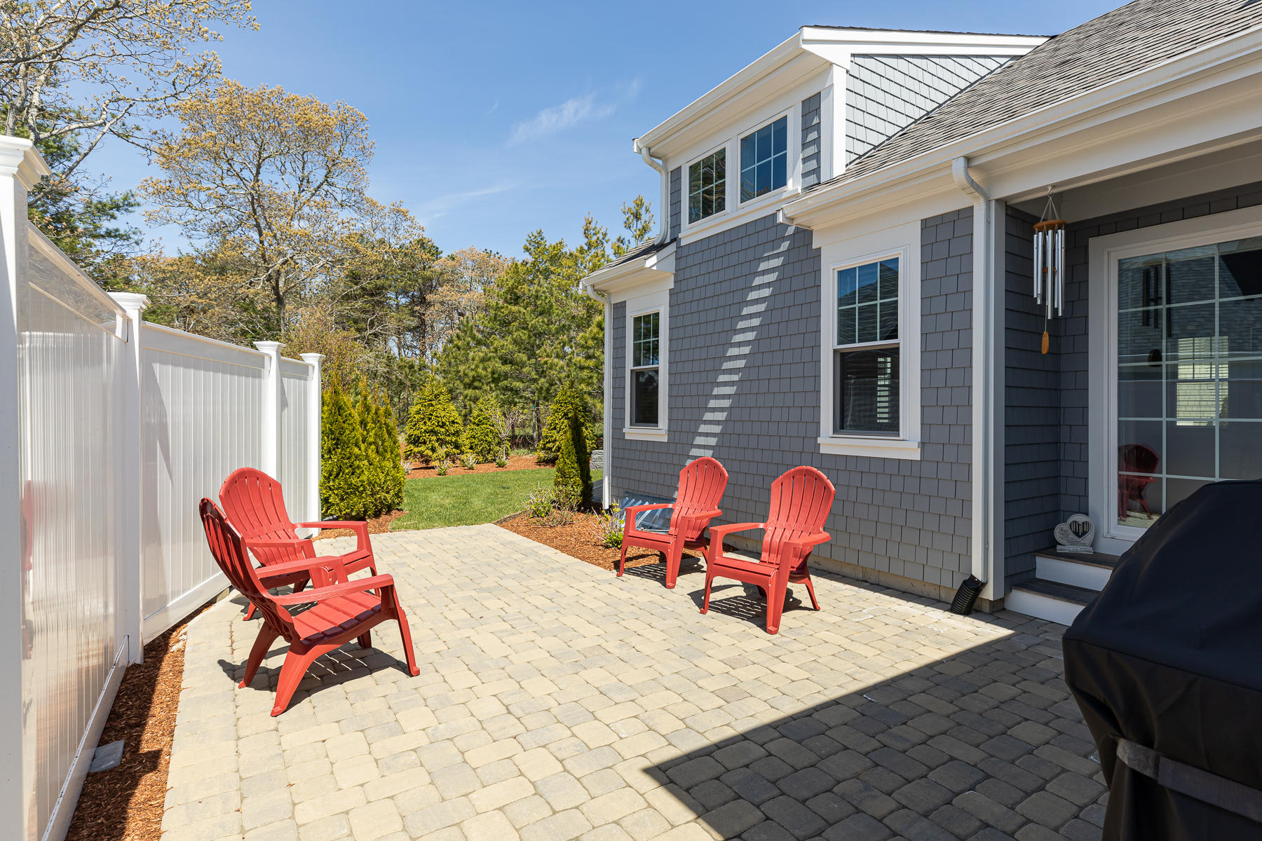 62 Cottage Lane Mashpee, MA 02649 - Photo 52 of 64 a backyard of a house with table and chairs