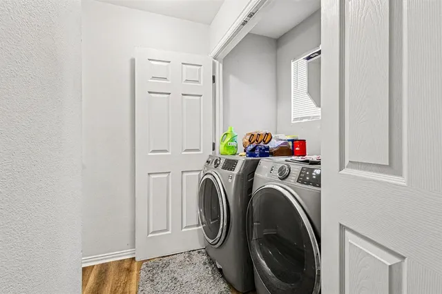 a backyard of a house with large trees and outdoor seating