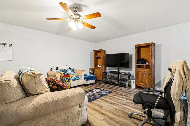 a living room with furniture and wooden floor
