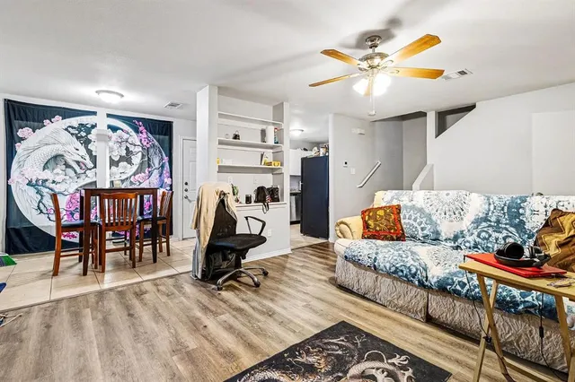 a kitchen with a sink a refrigerator and cabinets