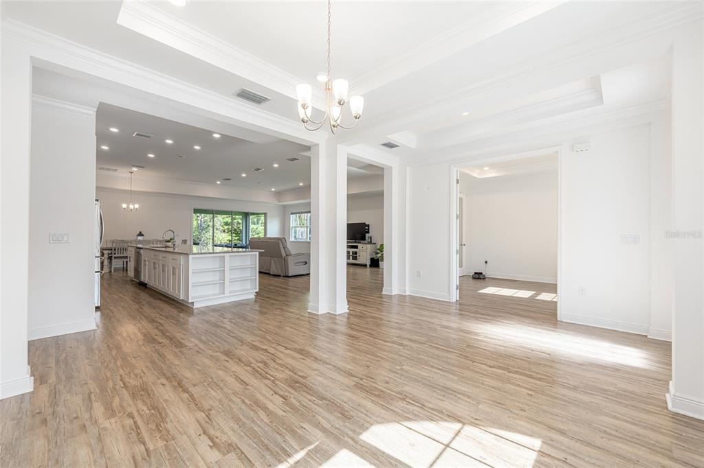 69 Grass Street Homosassa, FL 34446 - Photo 11 of 72 a view of a hallway with wooden floor and a kitchen