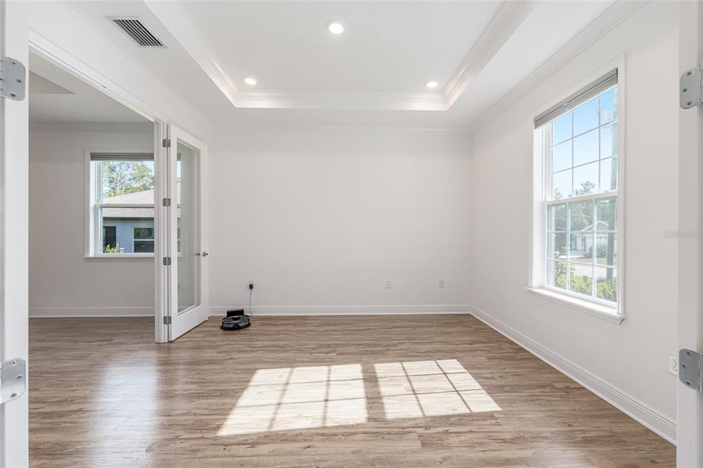 69 Grass Street Homosassa, FL 34446 - Photo 12 of 72 an empty room with wooden floor and windows