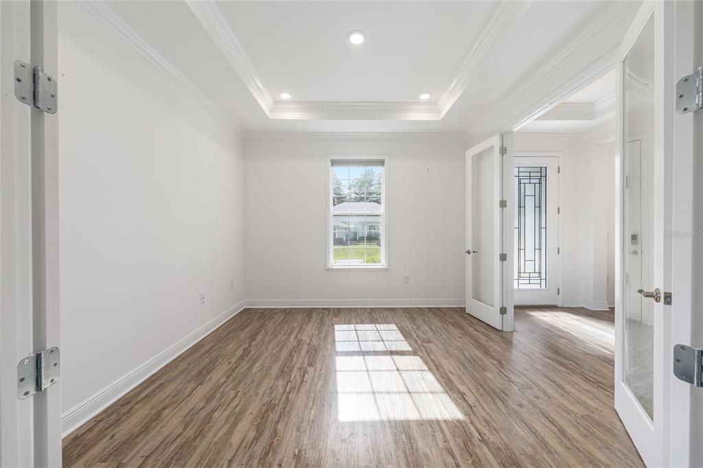 69 Grass Street Homosassa, FL 34446 - Photo 14 of 72 an empty room with wooden floor and windows